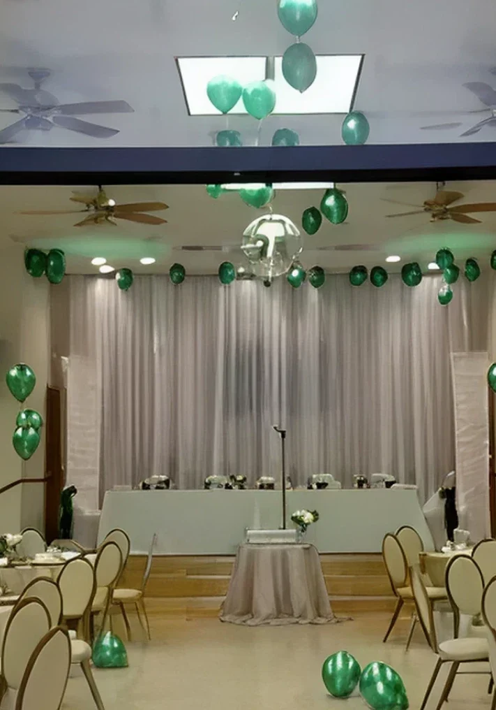 Wedding reception hall with green balloons.